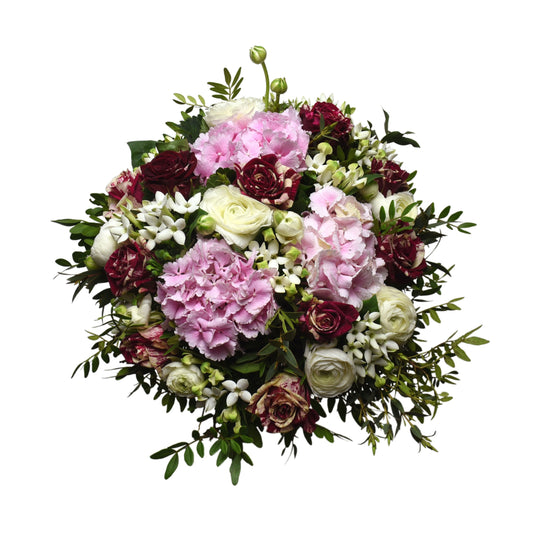 A hand-tied bouquet featuring deep antique pink roses, pink peonies, pink hydrangeas, pink syringe, and pink gerberas, complemented by green pistachio and eucalyptus leaves.