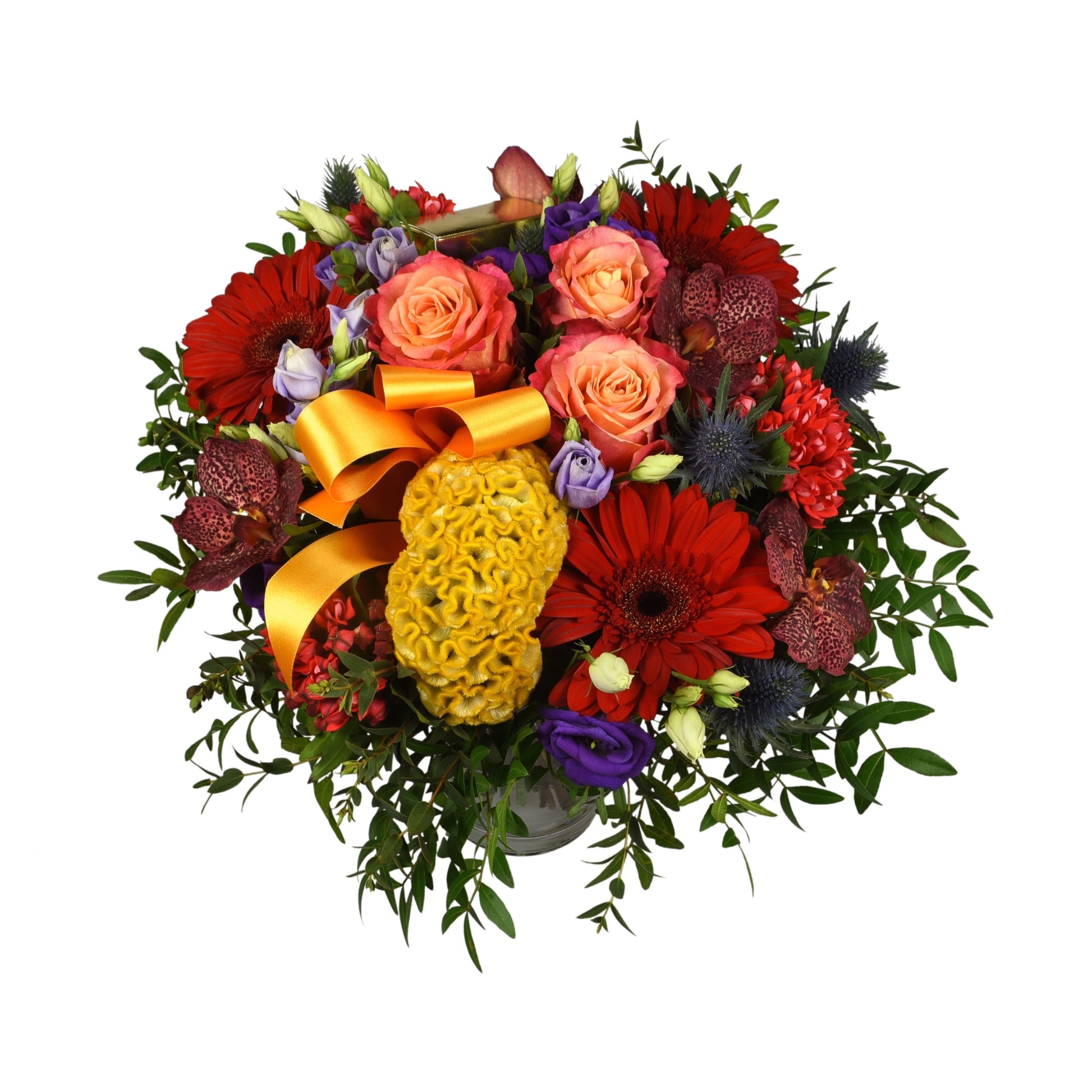 A luxurious hand-tied bouquet featuring a vibrant assortment of flowers including large-headed roses, celosia, eryngium, gerbera, Eustoma, and bouvardia in colors of red, yellow, blue, and lilac, tied with yellow and orange ribbons.