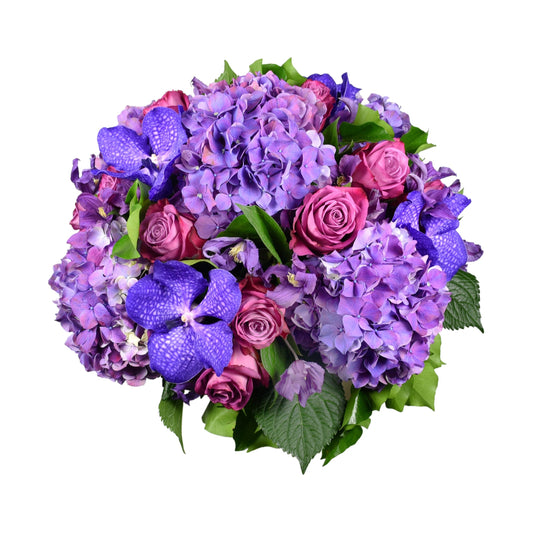 A bouquet of purple hydrangeas, pink roses, and vanda orchids with green leaves.