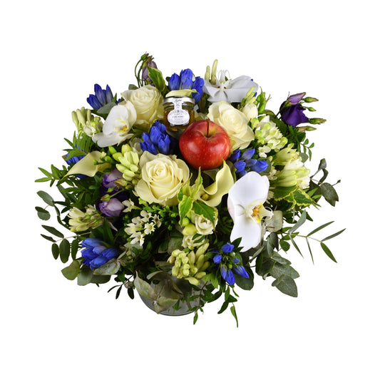 A hand tied bouquet featuring white and blue flowers, including roses and other varieties, with green foliage and decorative elements.
