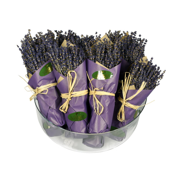 A luxury freeze-dried lavender bunch, with lavender flowers wrapped in purple paper and tied with a string, displayed in a clear container.